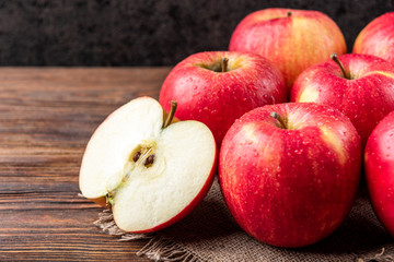 Red apples on dark wooden background.
