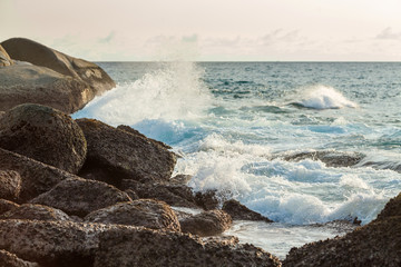 waves striking at the rocks of Ката beach on the Phuket island of Thailand