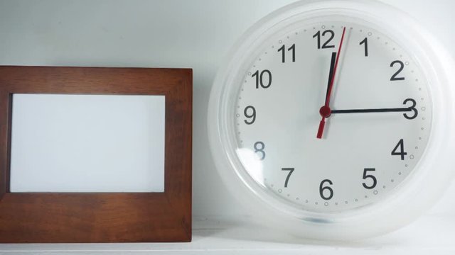 Lunch time. Close-up. White wall clock and picture frame on white background, Clock walking 40 minute, Time concept.