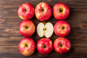 Red apples on dark wooden background.