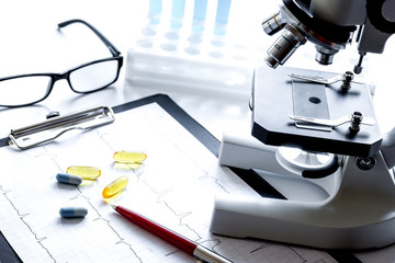 doctors desk with microscope and test tubes