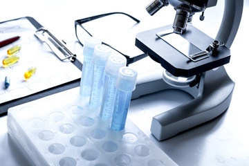 doctors desk with microscope and test tubes