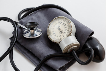 Concept for medicine. Vintage tonometer and stethoscope on white isolated background. View from...