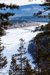 Fototapeta na wymiar View on the freezing siberian river in winter