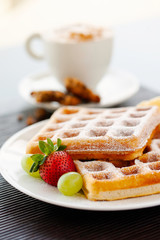 breakfast waffles with syrup strawberry banana coffee and cookies