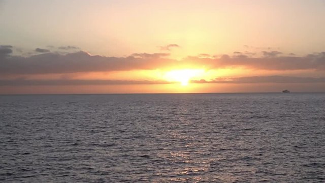 Canary Islands December 2018 - Time lapse of a Fred Olsen ferry passing in front of a sunset on the Atlantic Ocean.