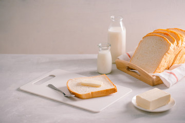 Sliced bread bake and butter on wooden tray. Simple breakfast