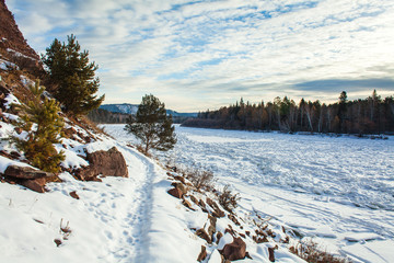 a path on a cliff's bottom on a sunny winter day