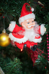 Santa Clous toy on a artificial xmas tree at home