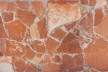 a flagstone wall of a house in winter