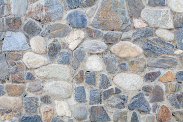 grey stone wall of the house in winter
