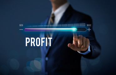 Profit growth, increase profit, raise profit or business growth concept. Businessman is pulling up progress bar with the word PROFIT on dark tone background. - obrazy, fototapety, plakaty