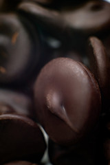 round pieces of chocolate for making chocolate glaze. macro.