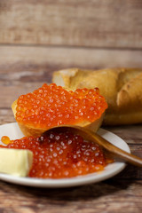 baguette sandwich with red caviar and butter.