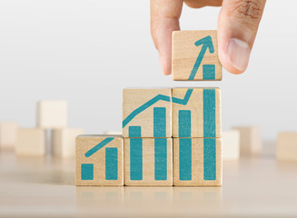 Business growth, progress or success concept. Wooden blocks with a growing bar chart graphic...
