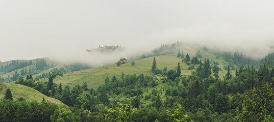 Little house on a green mountain slope