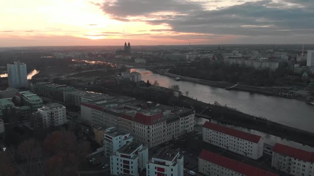 Lightning thunderstorm over a city sunset purple sky with a river and traffic and cathedral view. Magdeburg is a beautiful city.