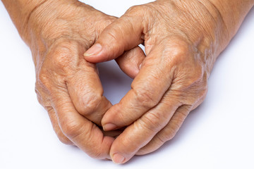 Fototapeta premium Senior woman's grasping her hands, wrinkled skin texture of blood in back of the hands on white background , Close up & Macro shot, Selective focus, Body part, Healthcare concept
