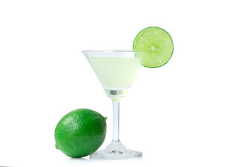 Glass of lime juice and lime fruits with green leaves isolated on white background