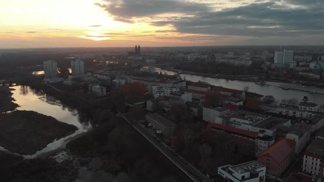 Thunderstorm over city sunset at wintertime with a river and a cathedral in the city.