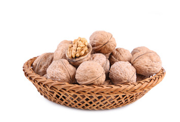 Walnuts in basket isolated on white background