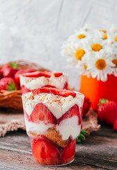 Strawberries with cream or tiramisu in small glasses 
