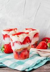 Strawberries with cream or tiramisu in small glasses 