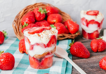 Strawberries with cream or tiramisu in small glasses 