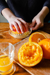 Woman squeezing oranges for fresh juice