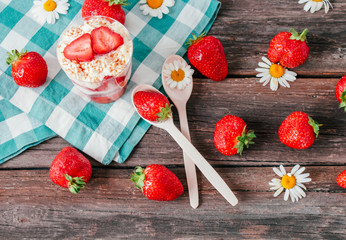 Strawberries with cream or tiramisu in small glasses 