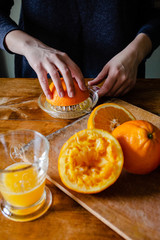 Woman squeezing oranges for fresh juice