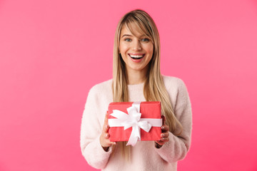 Cheerful young blonde girl standing isolated