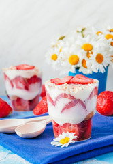 Strawberries with cream or tiramisu in small glasses 