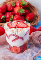 Strawberries with cream or tiramisu in small glasses 