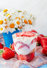 Strawberries with cream or tiramisu in small glasses 