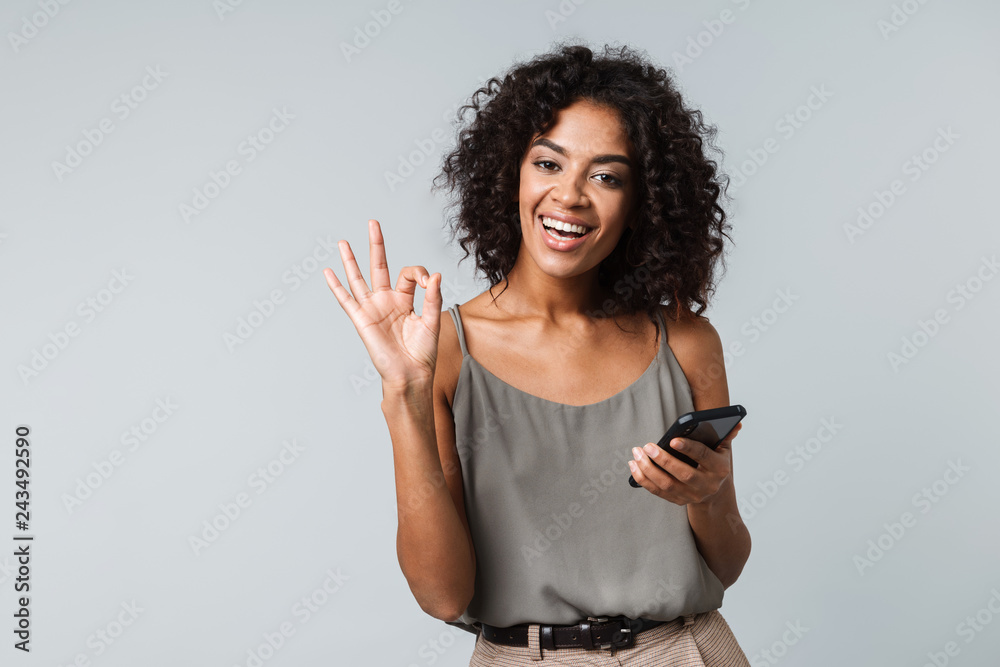 Poster happy young african woman casualy dressed standing