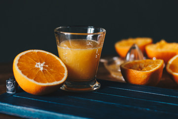 Oranges and squeezer on wooden table