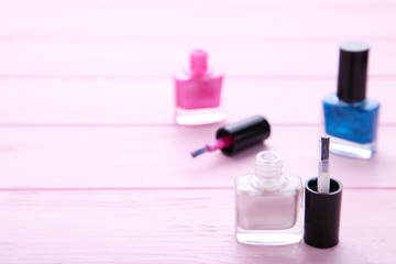 Group of bright nail polishes on pink