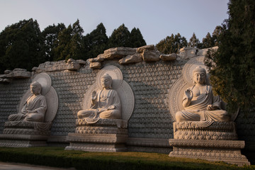 statues of the 3 Buddhas on The Thousand Buddha Mountain autumn evening, Jinan