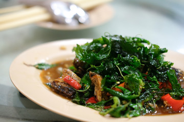 Stir-fried basil leave with fried preserved egg.