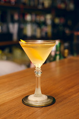 El Presidente Cocktail on bar counter.  (soft focus photo taken in poor lighting conditions, contains some noise)