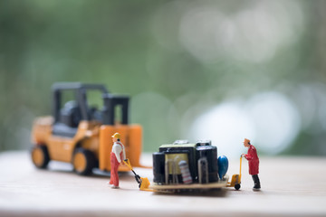 Miniature workers moving USB for repair.