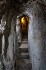 underground ancient stone tunnel with lights