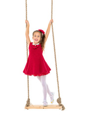 Little girl swinging on a swing