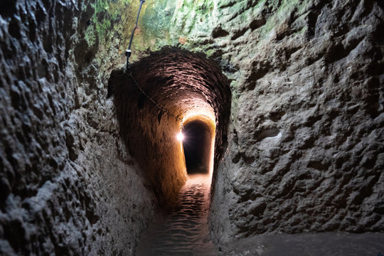 underground ancient stone tunnel with lights