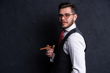 Portrait of an attractive business man with a cigar.