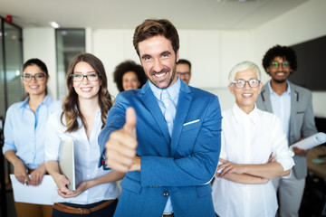 Fototapeta premium Successful team of young perspective businesspeople in office