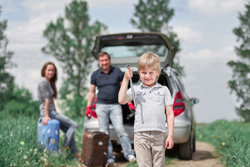 boy with a wrench standing on a country road. trouble on the road