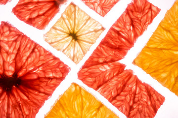 Top view of transparency square slices of fresh citrus fruits grapefruit lime lemon and orange