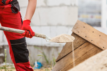 Person using shovel on construction site